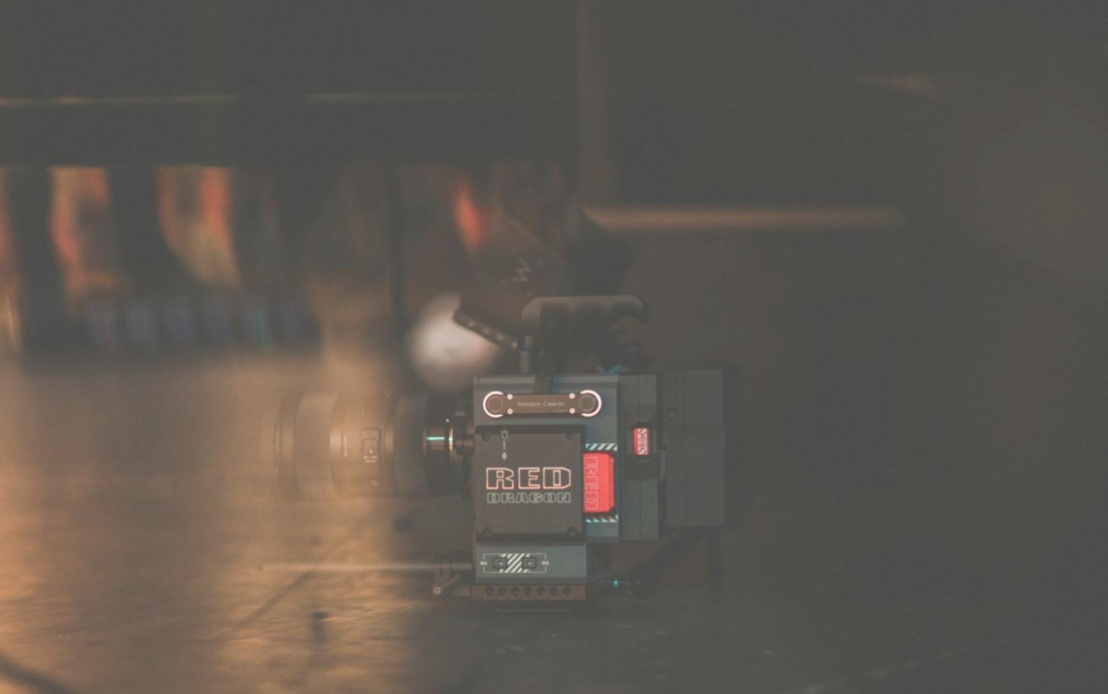 Hands adjusting professional audio mixer with editing software visible on screen