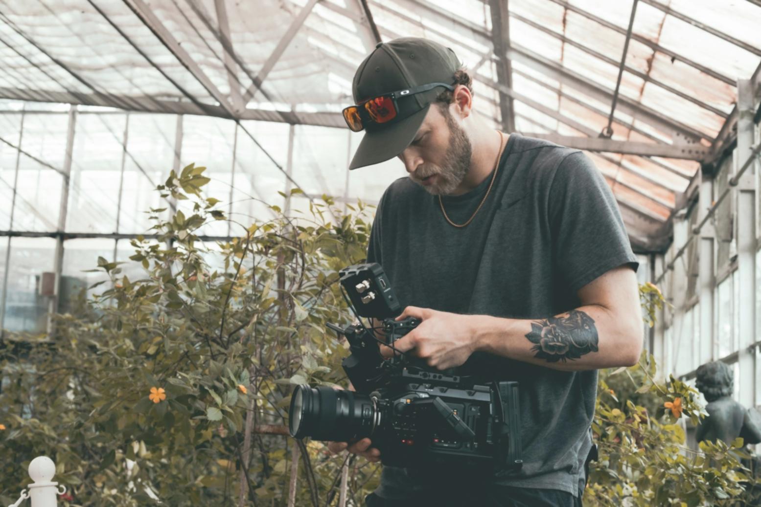 Collaborative workspace showing team reviewing video project on large display